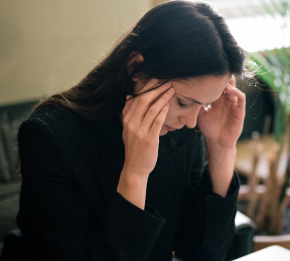 Giovane donna che si tocca le tempie doloranti